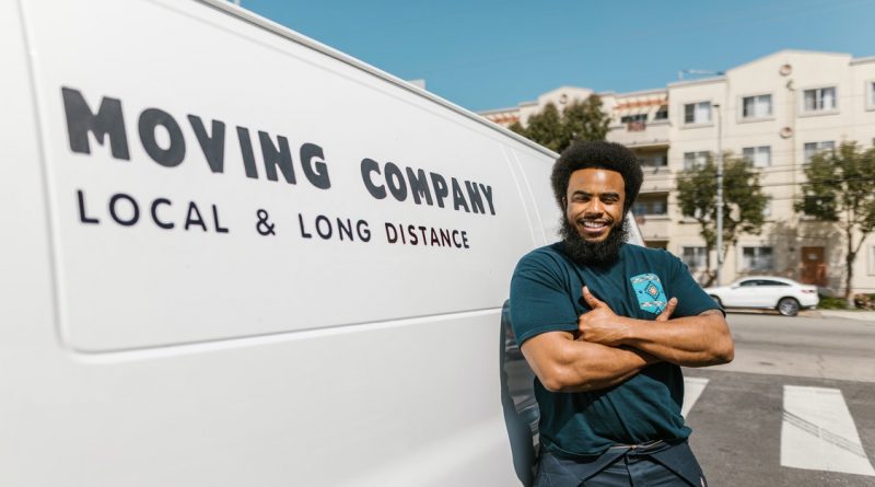 Man standing beside moving van 800x445 - What Do Interstate Movers Do – A Look Into their Job and Duties  