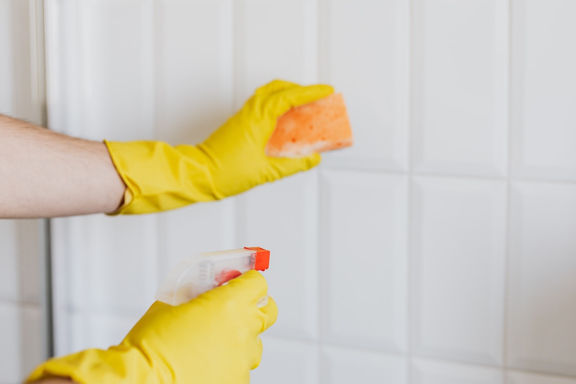 Scrubbing bathroom walls 1 - The Incredible Benefits of Powerwashing Your Home Or Business
