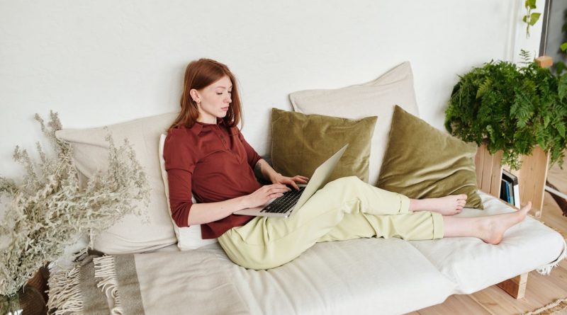 Woman using laptop on couch 1 800x445 - How to Design a Garden Room for Relaxation, Entertaining, Or Dining