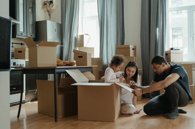Family playing around boxes 2 - 5 Ways You Can Sell Your House Easily