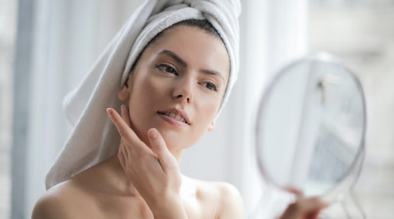Woman checking her face in the mirror 800x445 - Advantages of Getting a Botox Treatment 