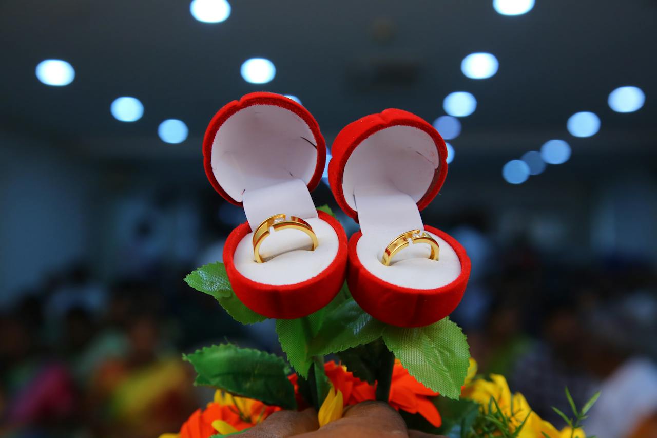 gold rings inside red ring boxes - Metal Wedding Bands Explored