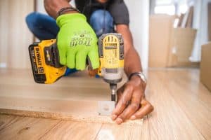 man using a power drill for home improvement on a wooden floor with precision 300x200 - man using a power drill for home improvement on a wooden floor with precision..jpg