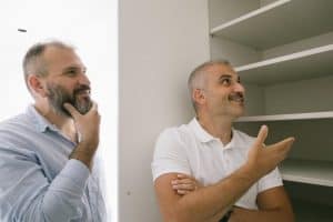 two men engage in a conversation about a shelving unit in a bright indoor setting 300x200 - two men engage in a conversation about a shelving unit in a bright indoor setting..jpg