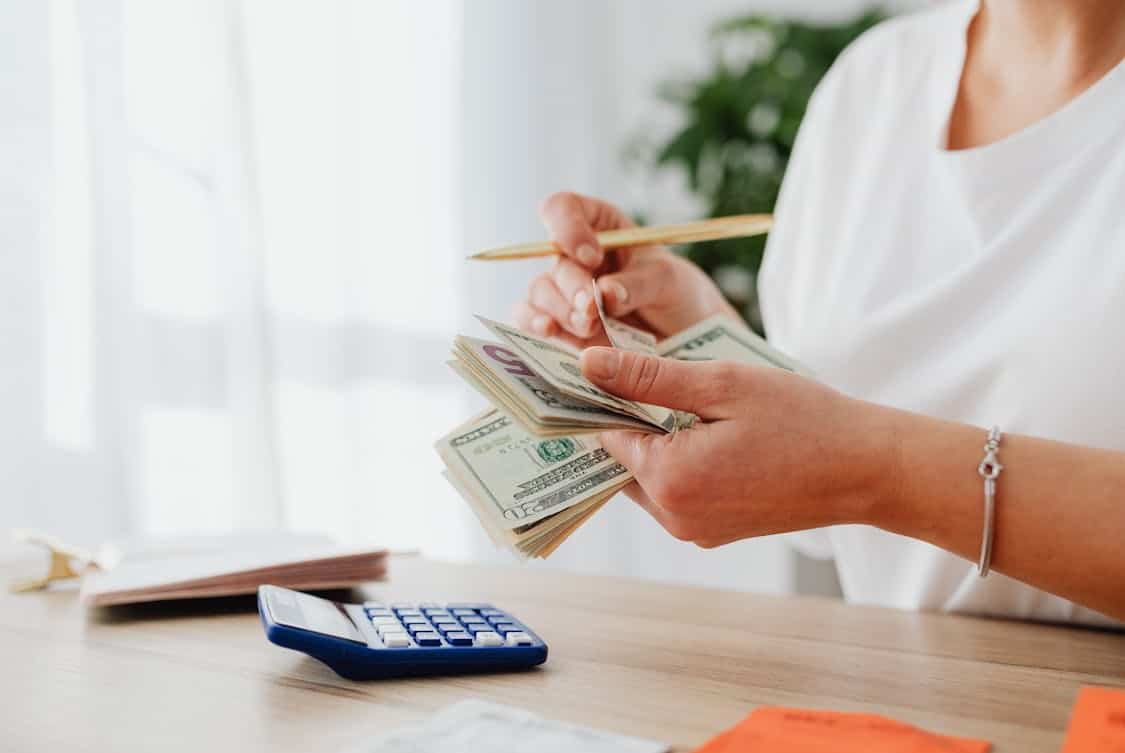 woman counting money - How to Minimize Risks in Bullion Investing for Beginners