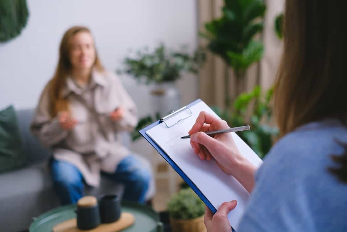 psychologist taking notes during appointment - 5 Key Benefits of Choosing Luxury Rehab for Executives