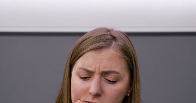 A Woman in Pain Holding Her Cheek 390x205 - Why Ignoring Dental Pain Can Be a Dangerous Mistake