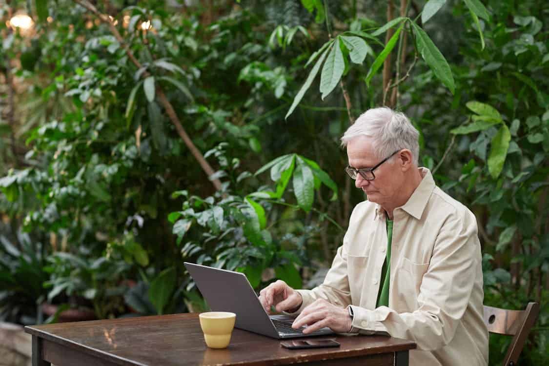 a man working on his laptop outdoor - Why Should You Invest in IT Services? Discover Now