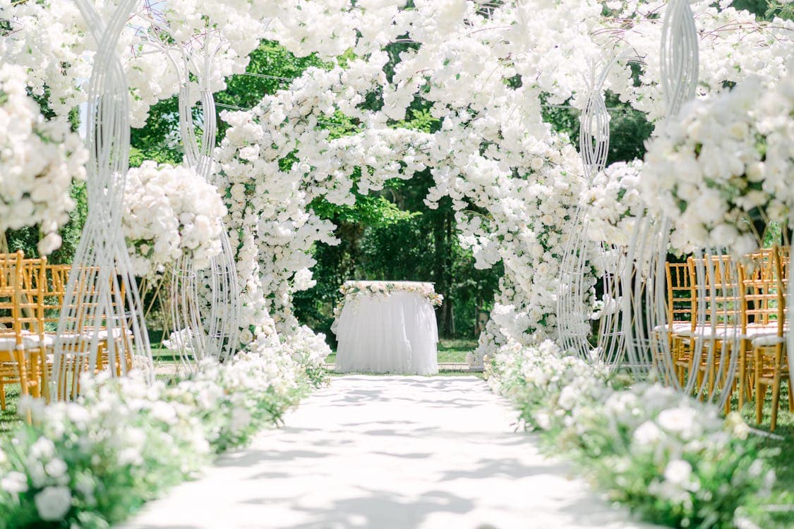 wedding setup in a garden - How to Use Flowers to Elevate Your Wedding Venue Decor